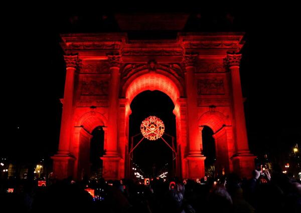 People take photos of the Olympic Flame in the cauldron during Milano Cortina 2026 Winter Olympics at Arco della Pace in Milan, Italy.
