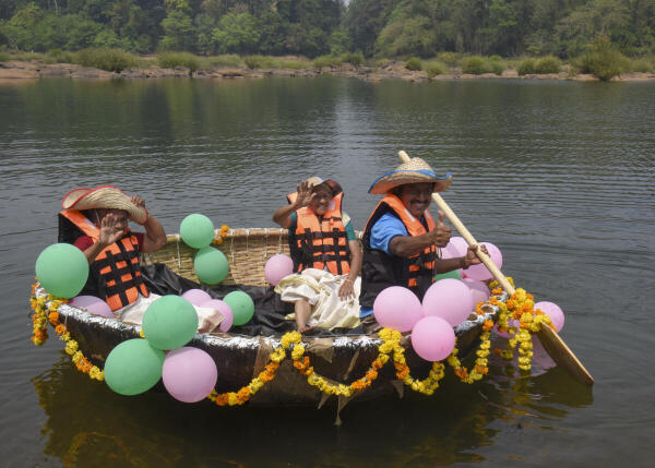 Visitors enjoy coracle, a bowl-shaped boat, ride in the Periyar River at Panamkuzhy Ecotourism Centre at Perumbavoor, near Kochi, Kerala.