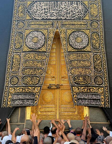 Muslims reach toward the Kaaba’s door during the holy month of Ramadan at the Grand Mosque in Mecca, Saudi Arabia.