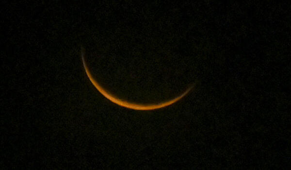 The waxing crescent moon appears in the sky, on the first day of the holy month of 'Ramzan', in Thiruvananthapuram, Kerala.