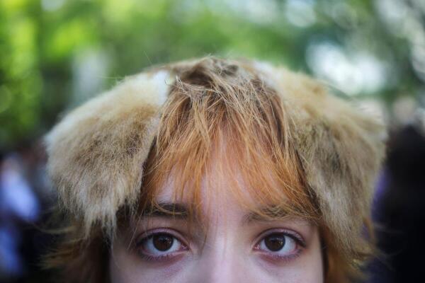 A teenager poses for a photo with fake animal ears on her head at a gathering of "Therians," a subculture whose members adopt animal characteristics, in Buenos Aires, Argentina.