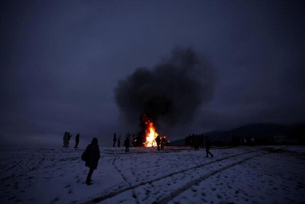 People gather around a bonfire during rituals in celebration of Sirni Zagovezni in Lozen.