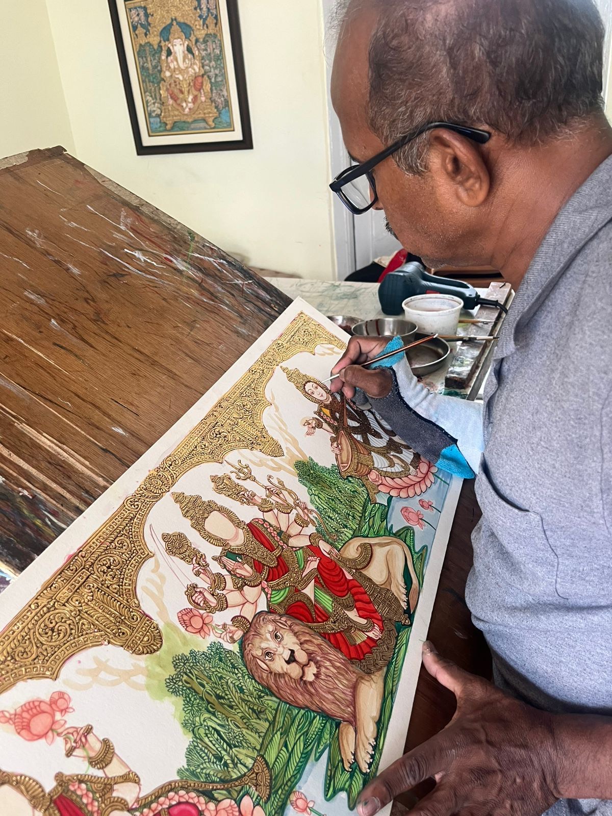Acclaimed artist Raghavendra B B creates a traditional Mysore painting. Photo: Divine Mysore Arts