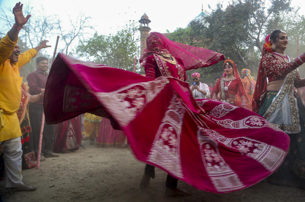 People take part in 'Lathmar Holi' celebrations at Shri Krishna Janmasthan Temple, in Mathura, Uttar Pradesh