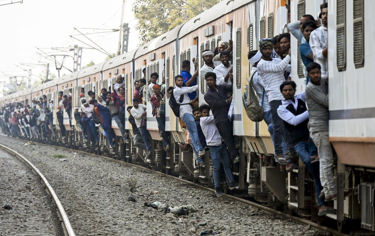 Passengers overcrowd a train ahead of the 'Holi' festival, in Patna, Bihar