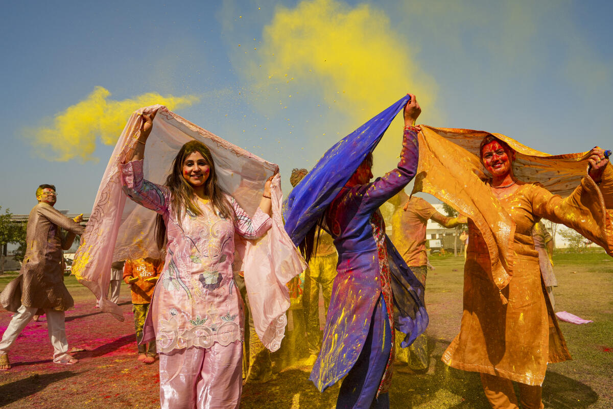 People use colours during celebrations ahead of the 'Holi' festival, at the 'ISKCON Temple', in Amritsar