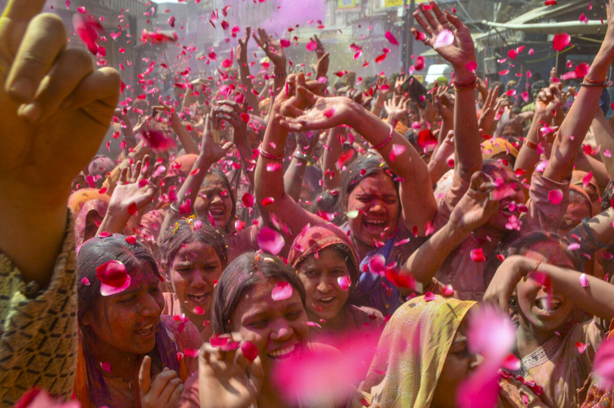 People celebrate with colours during the 'Holi' festivities, in Agra