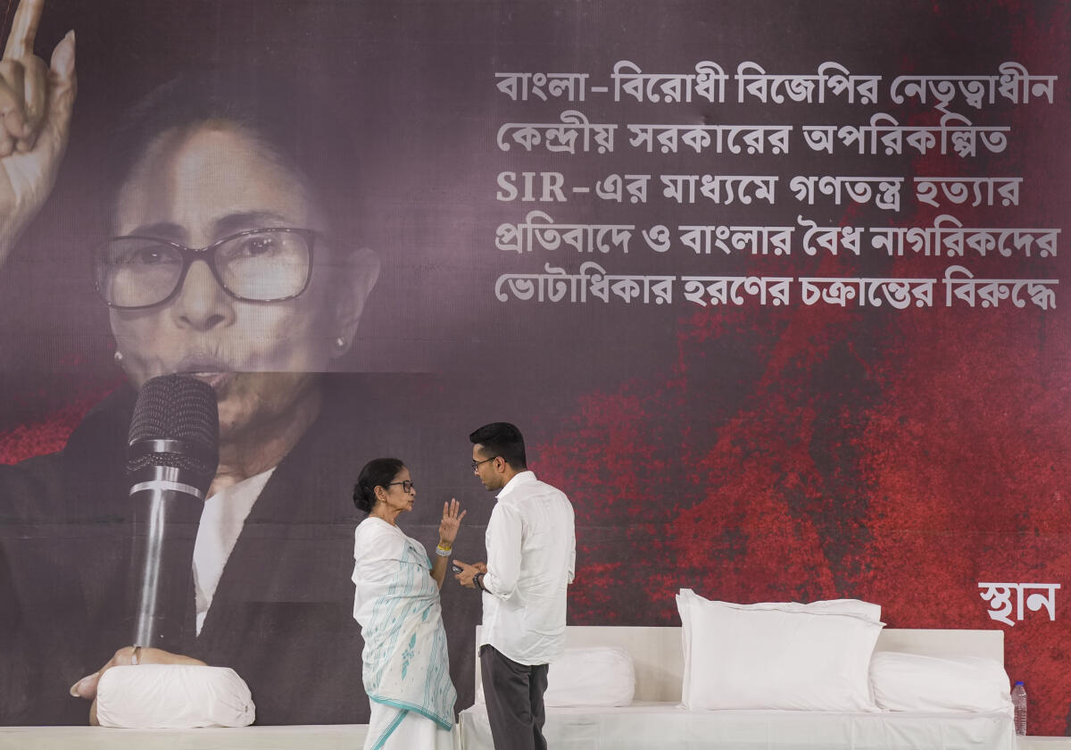 West Bengal Chief Minister Mamata Banerjee, left, with TMC National General Secretary Abhishek Banerjee during a sit-in protest against the alleged arbitrary deletions from the post-SIR electoral rolls in the state, in Kolkata. PTI