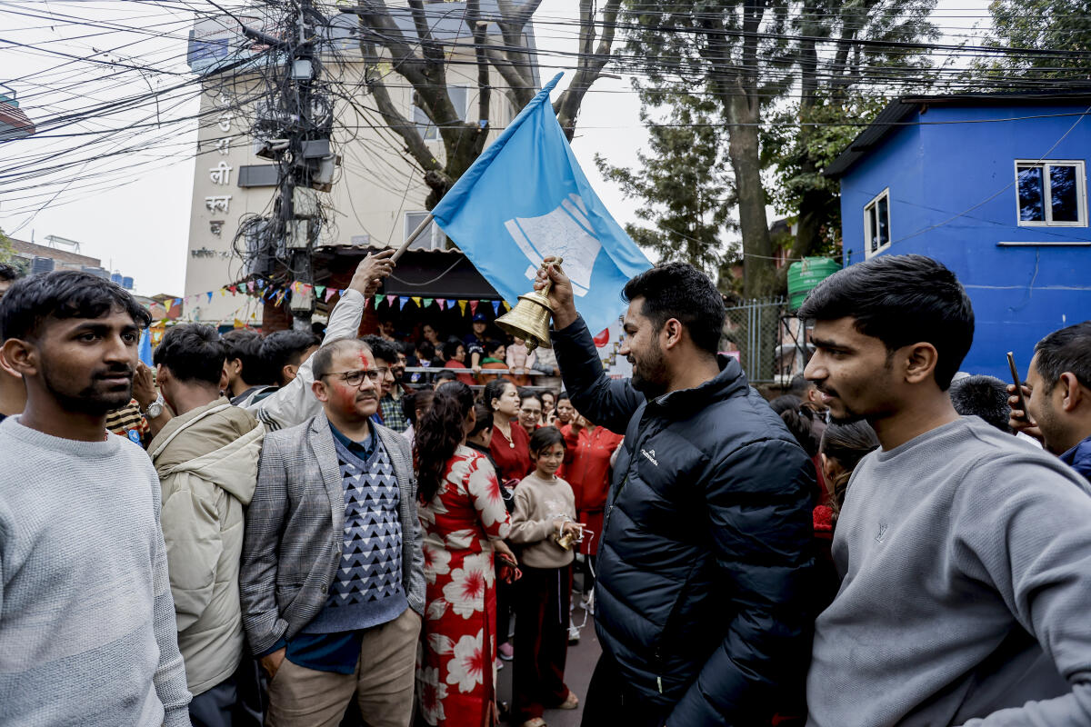 Supporters of the Rastriya Swatantra Party (RSP) ring a bell, the party’s election symbol, outside the Election Commission ahead of the announcement of results in the Nepal general elections, in Kathmandu, Nepal. PTI
