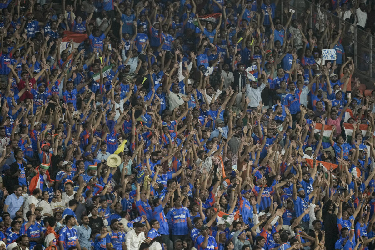 Spectators cheer during the ICC Men's T20 World Cup 2026 final cricket match between India and New Zealand at the Narendra Modi Stadium.