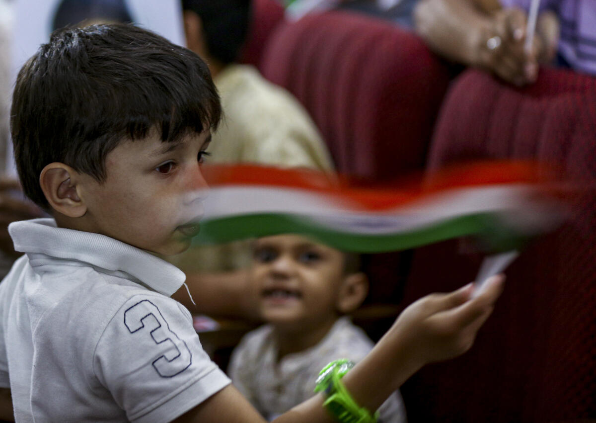 A child waves the Indian national flag during the International Quds Day Conference, in New Delhi, Friday, March 13, 2026.