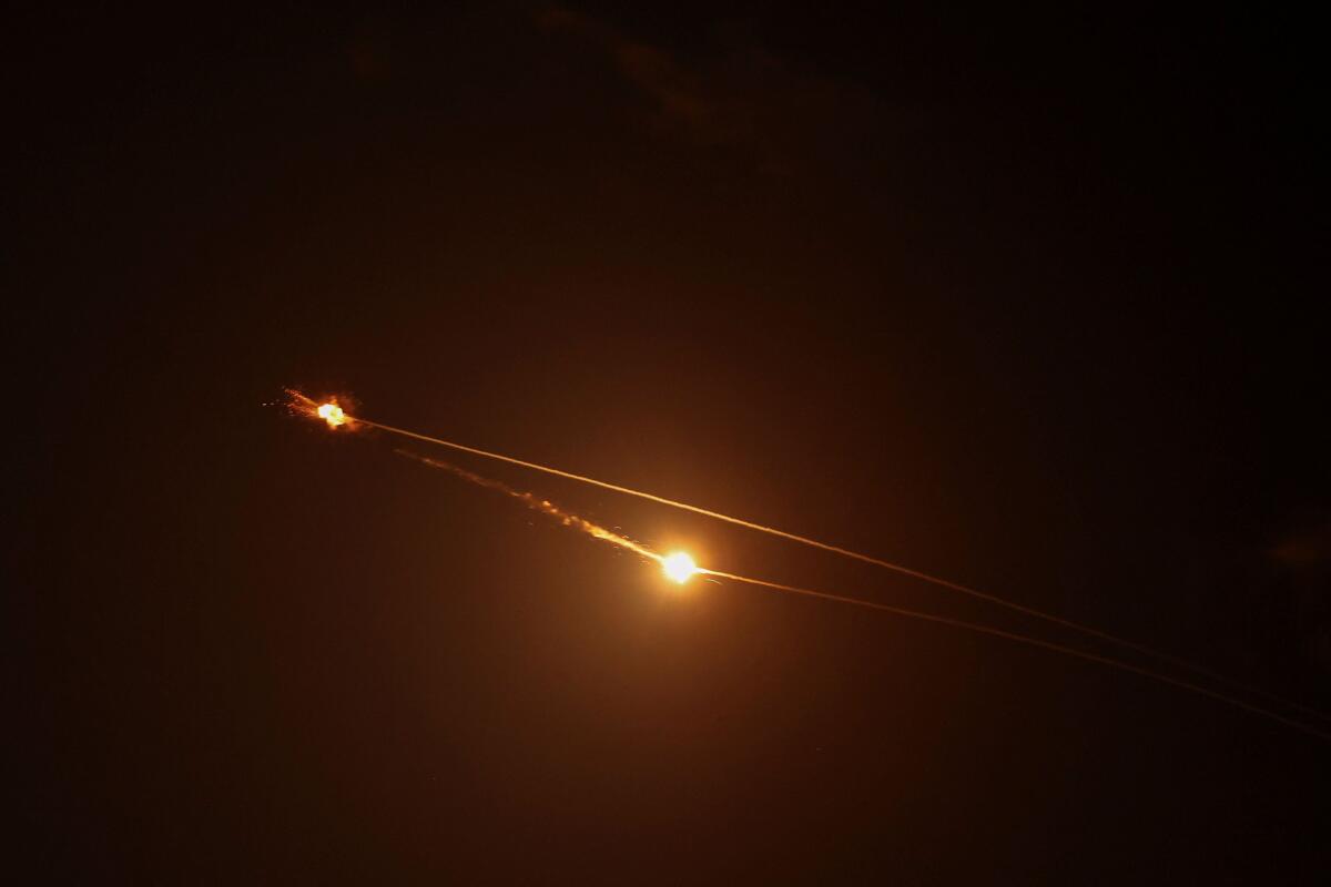 Streaks of light illuminate the sky during an interception attempt amid the U.S.-Israeli conflict with Iran, as seen from Tel Aviv, Israel March 15, 2026.
