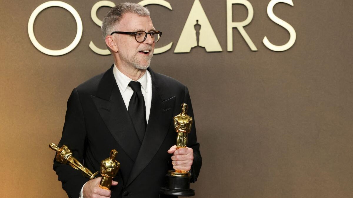 Paul Thomas Anderson poses with the Oscars for Best Adapted Screenplay, Best Director, and Best Picture for One Battle After Another.