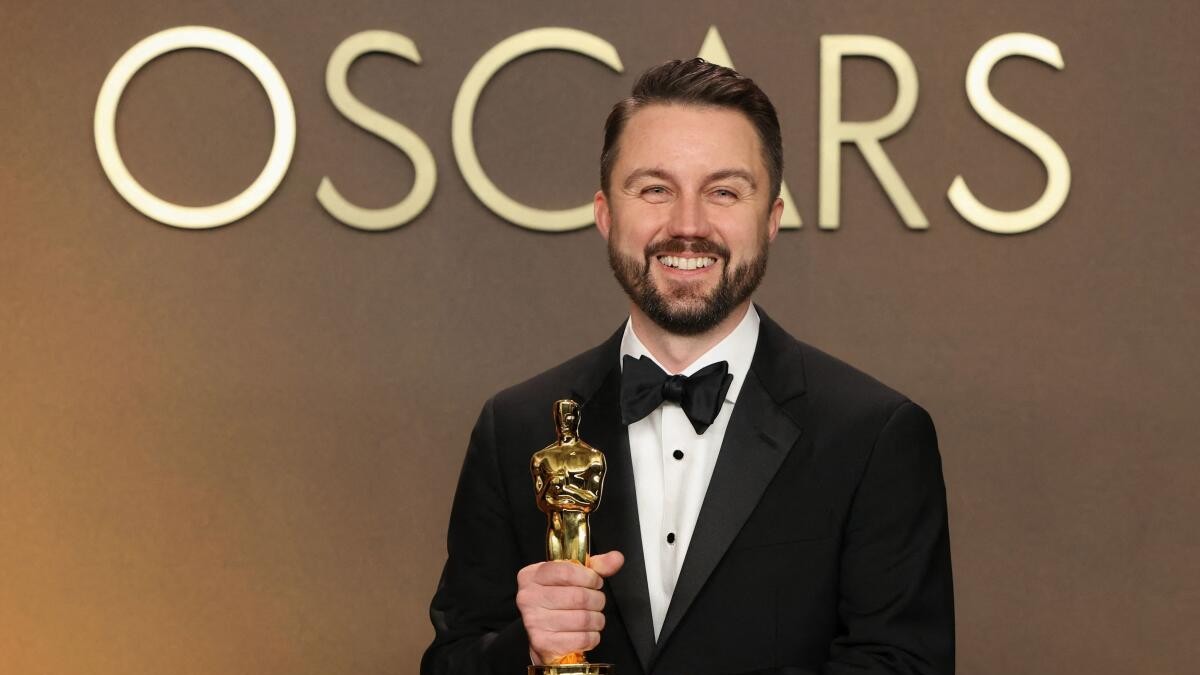 Andy Jurgensen poses with the Oscar for Best Film Editing for One Battle After Another.