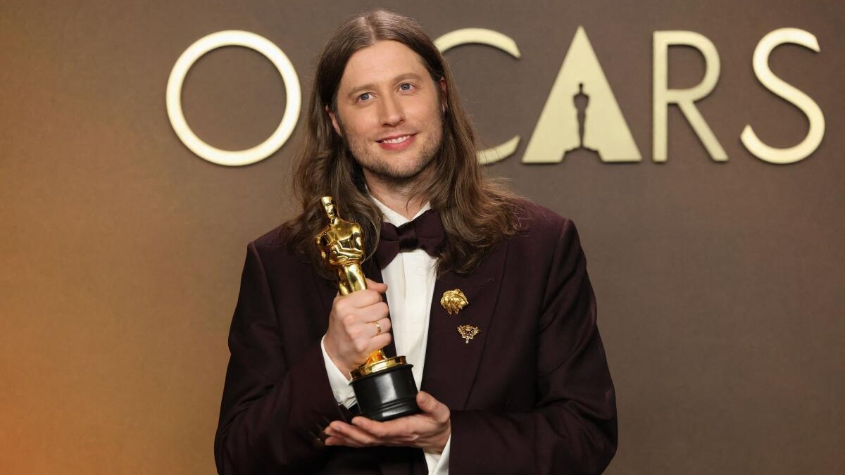 Ludwig Goransson poses with the Best Original Score award for Sinners.