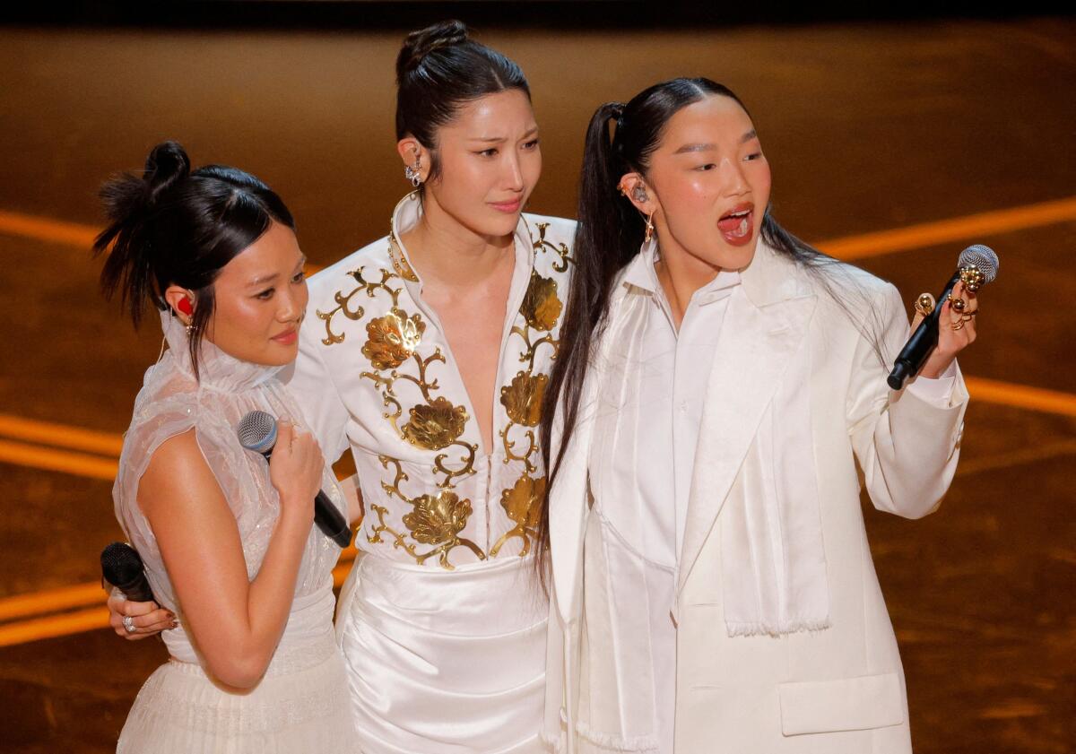 Rei Ami, EJAE, and Audrey Nuna from KPop Demon Hunters react as they perform on stage during the Oscars show at the 98th Academy Awards in Hollywood, Los Angeles, California, U.S., March 15, 2026.