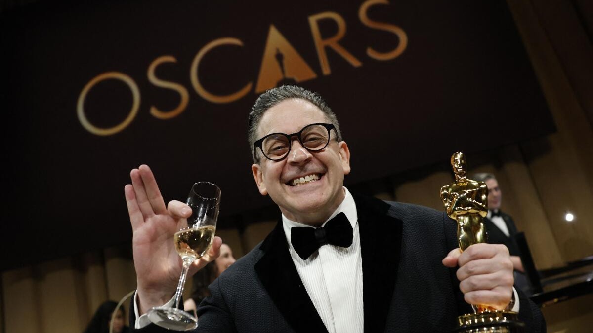 Gary A Rizzo poses with the Oscar for Best Sound for F1.