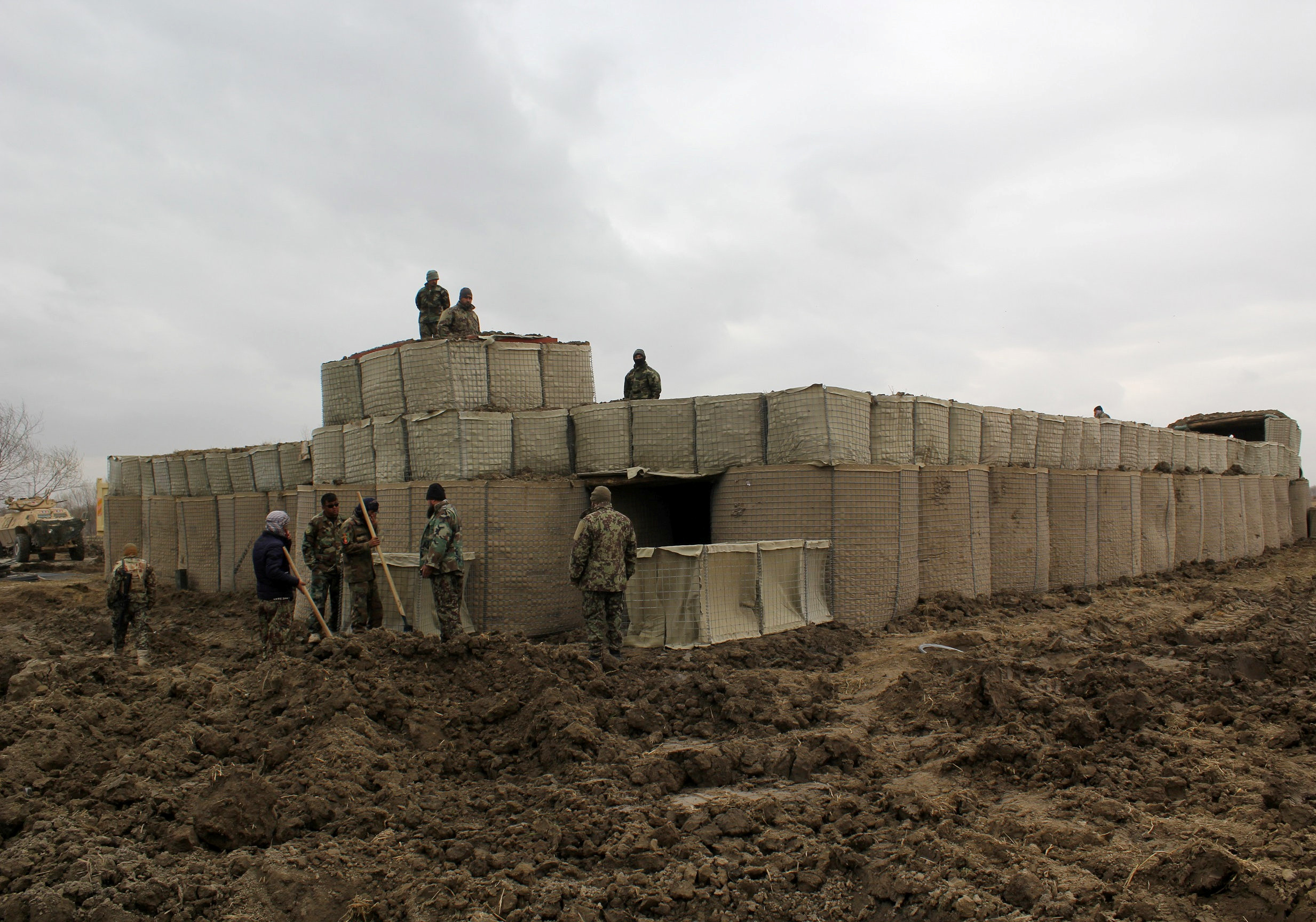 Afghan National Army (ANA) soldiers stand at a checkpost, where last night clashes took place between Taliban and Afghan forces in Kunduz, Afghanistan