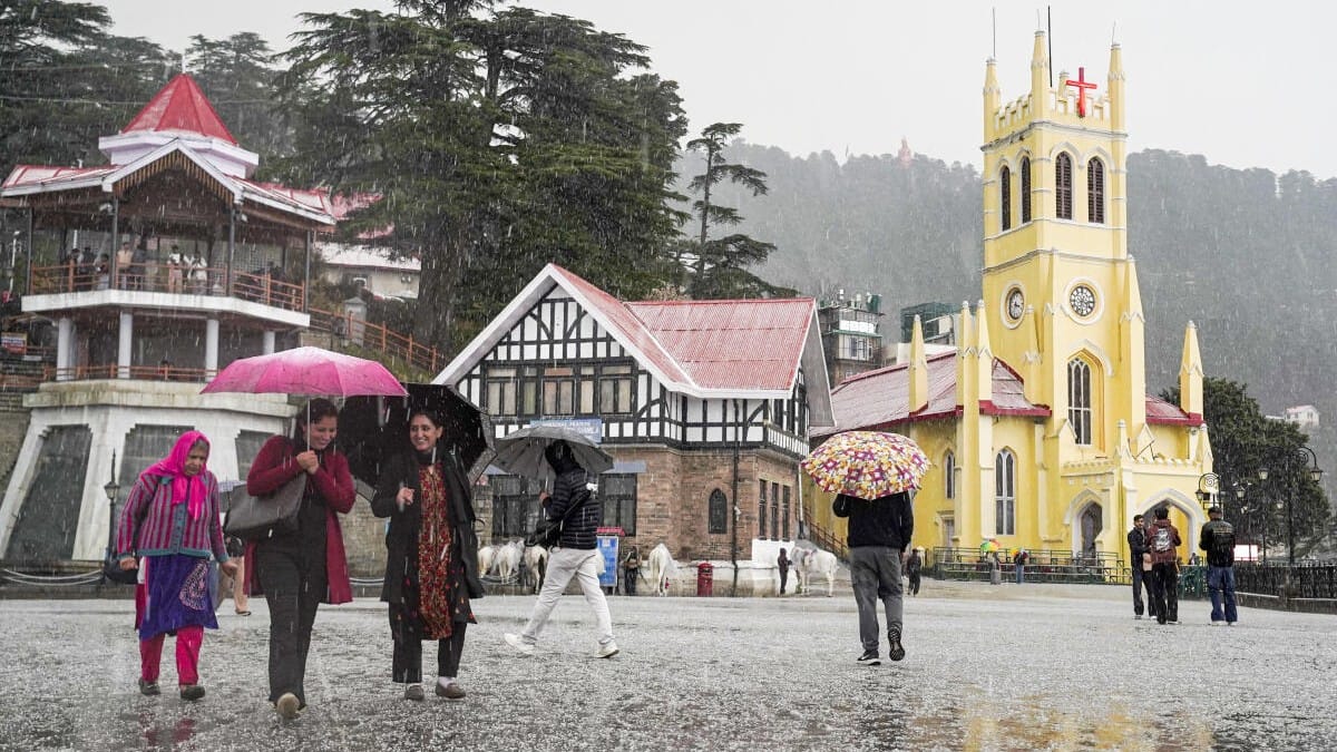 Pedestrians hold umbrellas during a hailstorm, in Shimla, Monday, March 16, 2026.