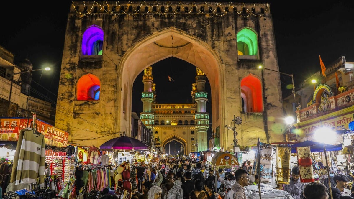 People shop at a busy street market near Charminar decorated with lights during Ramzan ahead of Eid al-Fitr, in Hyderabad, Monday, March 16.