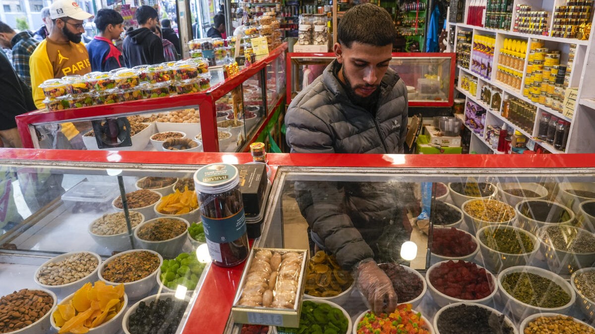 A vendor arranges dry fruits and confectionery items at a shop ahead of Eid al-Fitr during the holy month of Ramadan, in Srinagar.