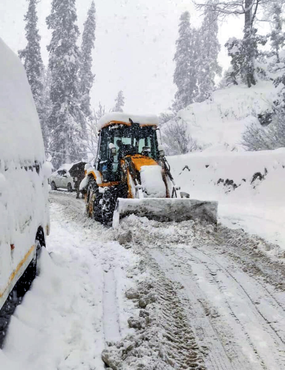 Border Roads Organisation personnel clear snow from a road near Atal Tunnel, in Kullu district of Himachal Pradesh, Tuesday, March 17, 2026.