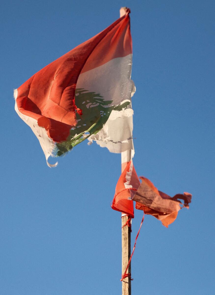 A Lebanese flag at the top of Al-Jaafareya High School, which is being used as a shelter for displaced families from Majdal Zoun in southern Lebanon, following an escalation between Hezbollah and Israel amid the U.S.-Israeli conflict with Iran, after they arrived in Tyre, Lebanon, March 17, 2026. 