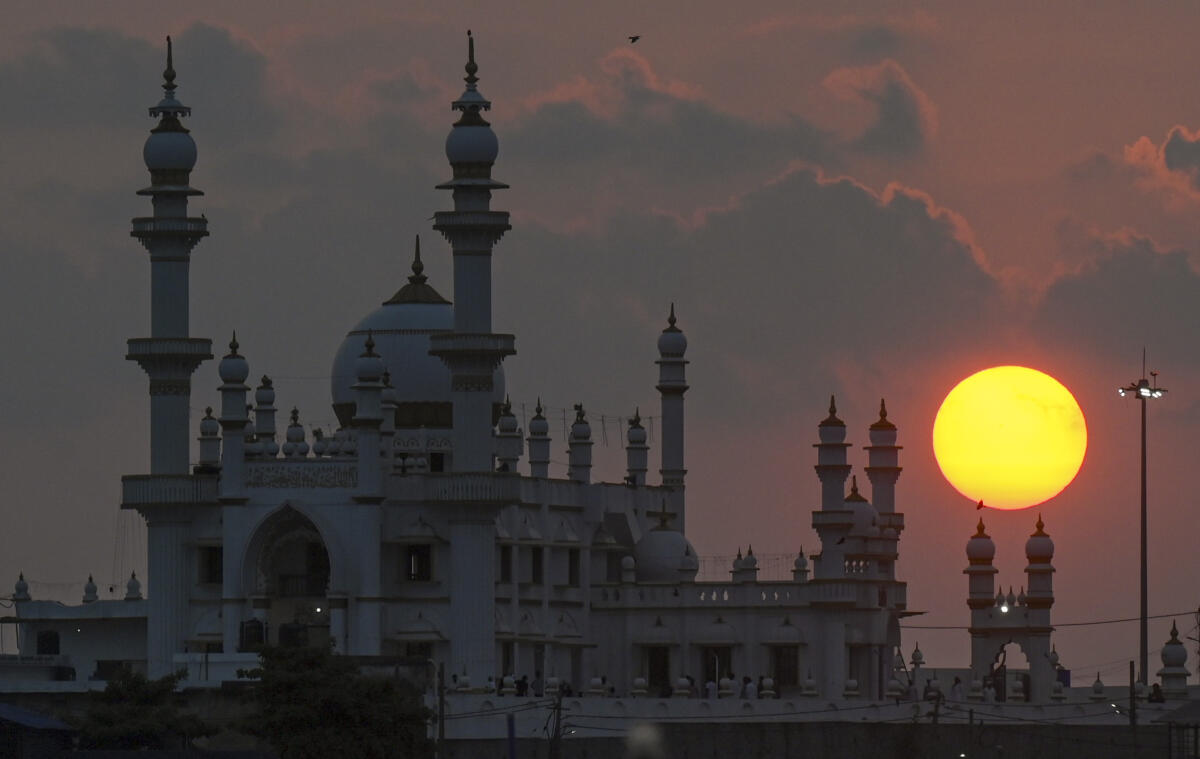 The sun sets behind Vizhinjam Mosque during the holy month of Ramzan, in Thiruvananthapuram, Tuesday, March 17, 2026. 