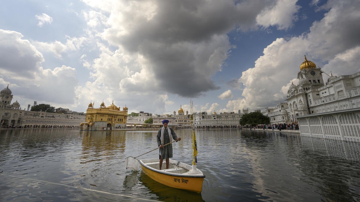 Dark clouds hover over the Golden Temple, in Amritsar, Friday, March 20, 2026.