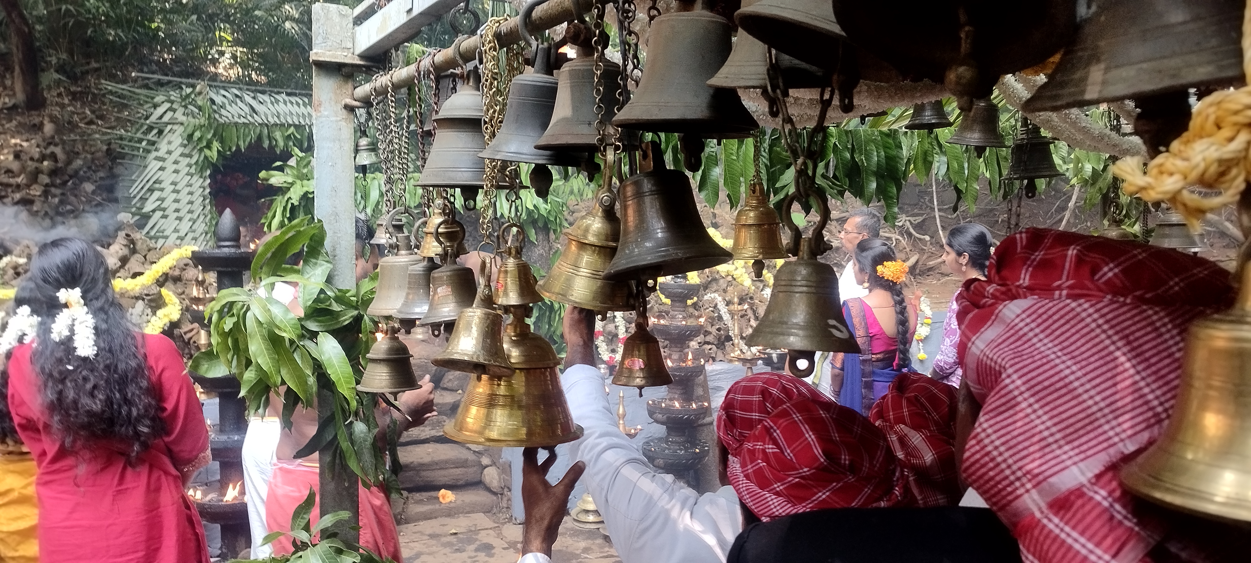 Devotees ring bells at the open-air shrine at Malethirike atop Somagiri near Kakkabe in Kodagu. Photo by author
