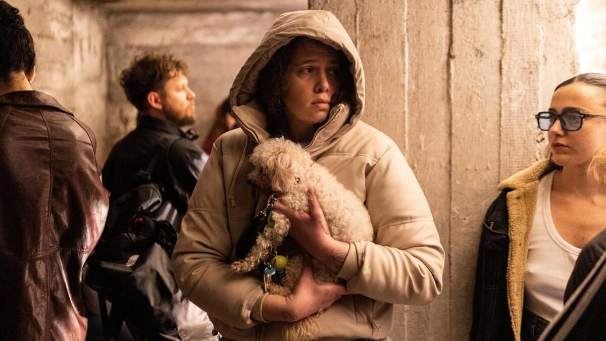 A woman in Jaffa holds her dog as sirens sound following the launch of a barrage of Iranian missiles towards Israel.