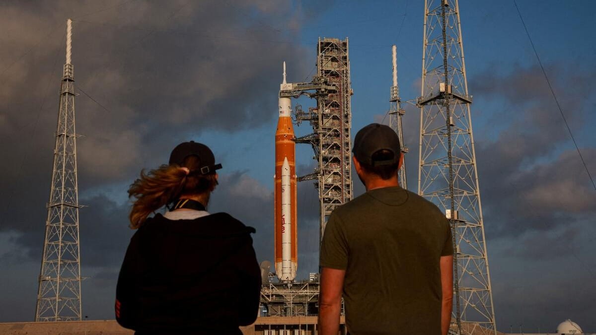People look at NASA's Space Launch System (SLS) rocket on Pad 39B at the Kennedy Space Center in Cape Canaveral, Florida.