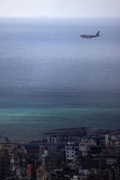 A Lebanese Middle East Airlines (MEA) aircraft approaches the Beirut-Rafic Hariri International Airport as it flies over Beirut's southern suburbs, amid escalating hostilities between Israel and Hezbollah, as the US-Israeli conflict with Iran continues, Lebanon.