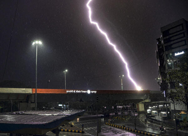 Lightning streaks across the sky as rain falls, in Nagpur.