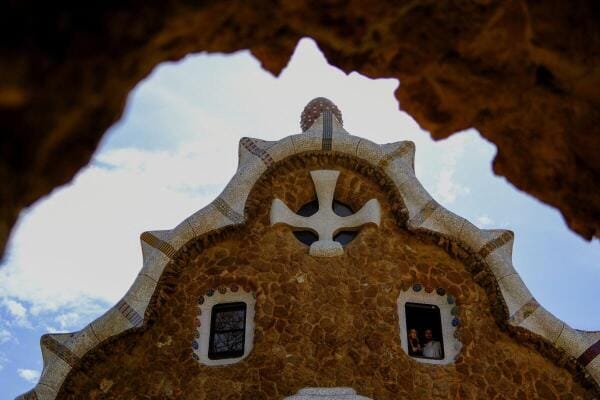 Tourists enjoy the Park Guell, designed by Catalan architect Antoni Gaudi, during the Holy Week in Barcelona, Spain.