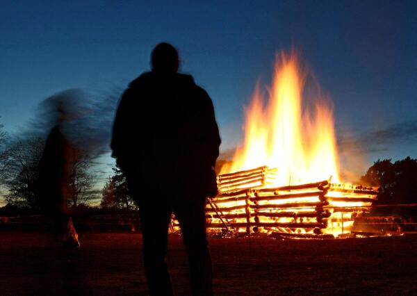 Logs arranged to resemble the Titanic ship stand in flames as people attend the traditional Easter bonfire in Trechwitz, Germany.
