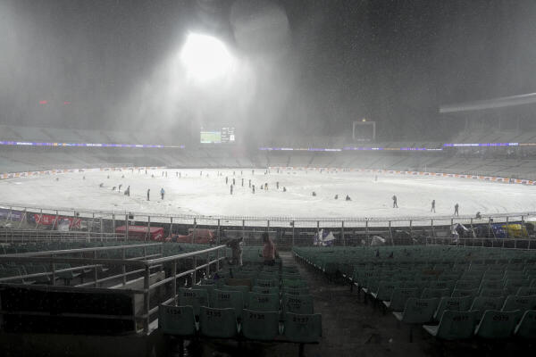 Ground staff cover the ground during rain interruption in an Indian Premier League (IPL) 2026 cricket match between Kolkata Knight Riders and Punjab Kings at Eden Gardens in Kolkata.
