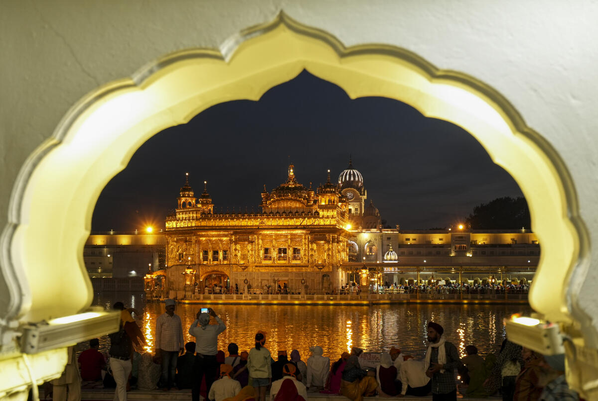 People gather to offer prayers at Golden Temple on the eve of Baisakhi, in Amritsar