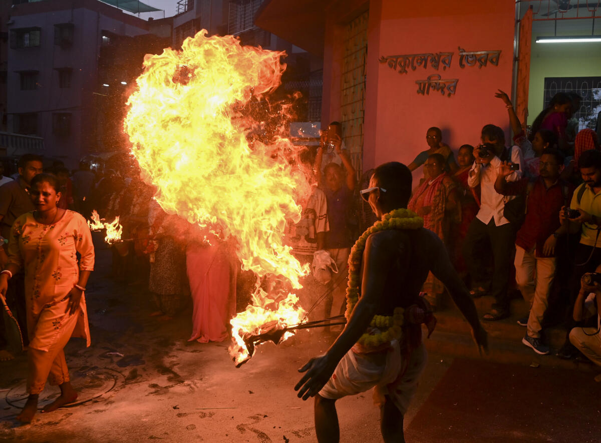 Devotees perform a ritual during the ‘Gajan’ festival, at Kalighat in Kolkata