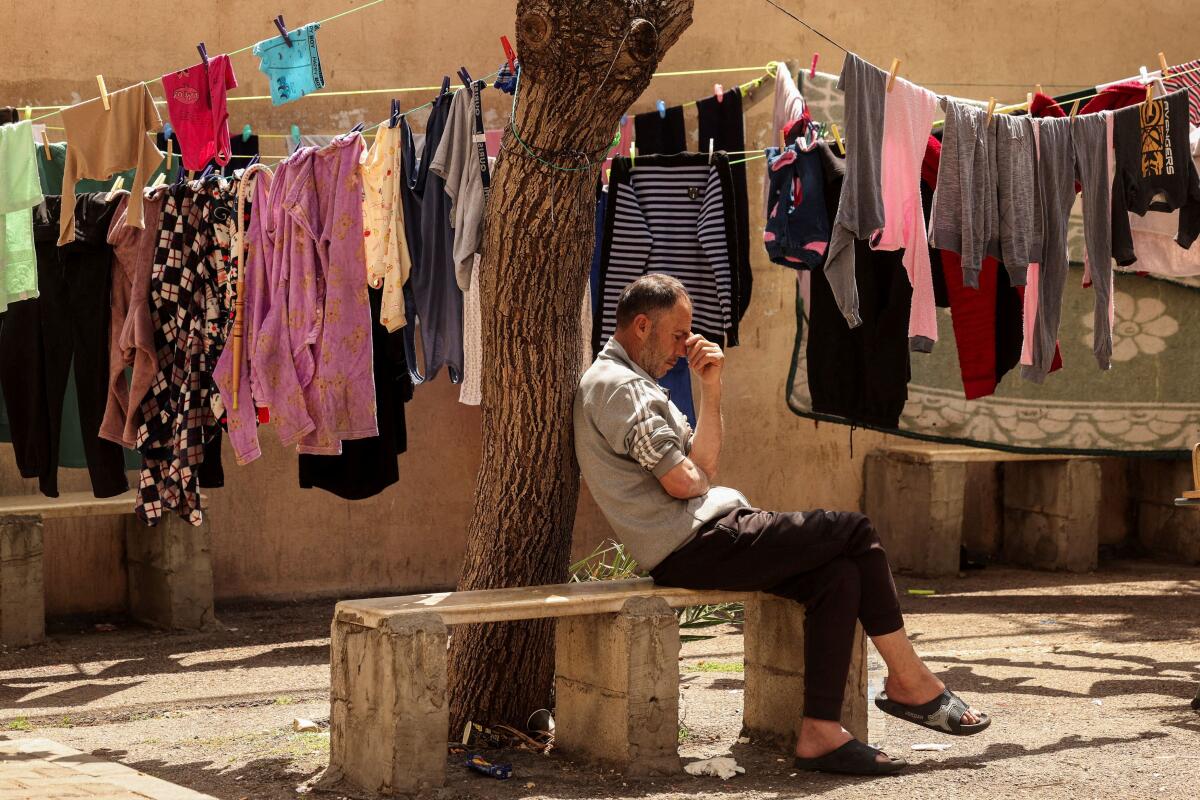 A displaced man, who fled his home after an Israeli evacuation order, sits in a university-turned-shelter in Sidon, Lebanon