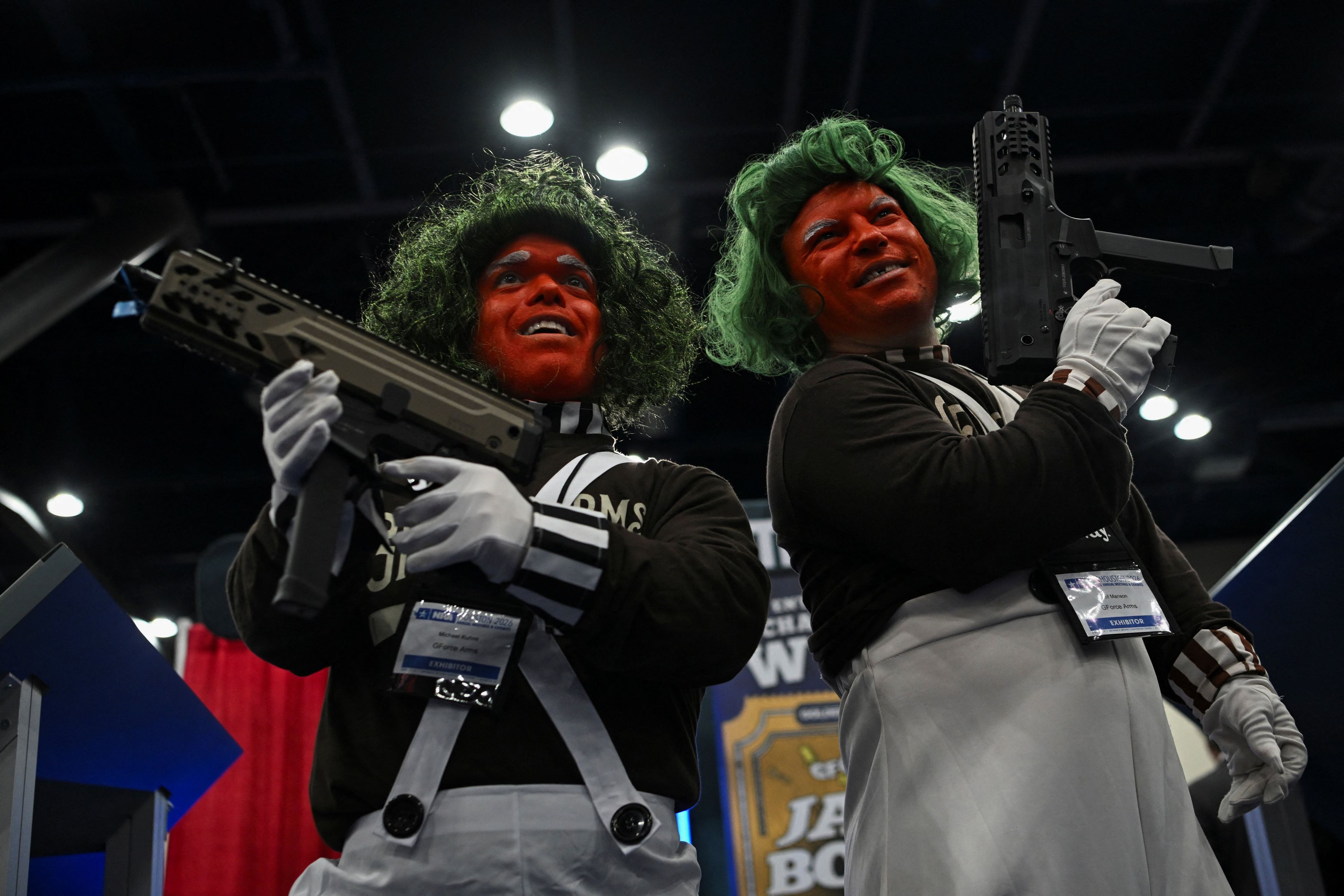 Exhibitors dressed as Oompa-Loompas hold guns during the National Rifle Association's (NRA) annual meetings and exhibits in Houston, Texas. Reuters