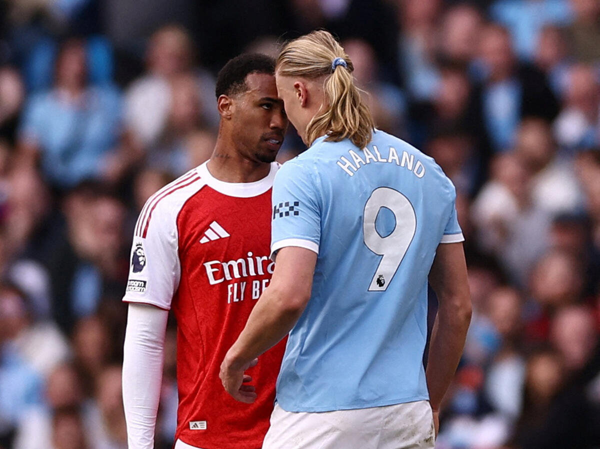 Arsenal's Gabriel Magalhaes clashes with Manchester City's Erling Haaland.