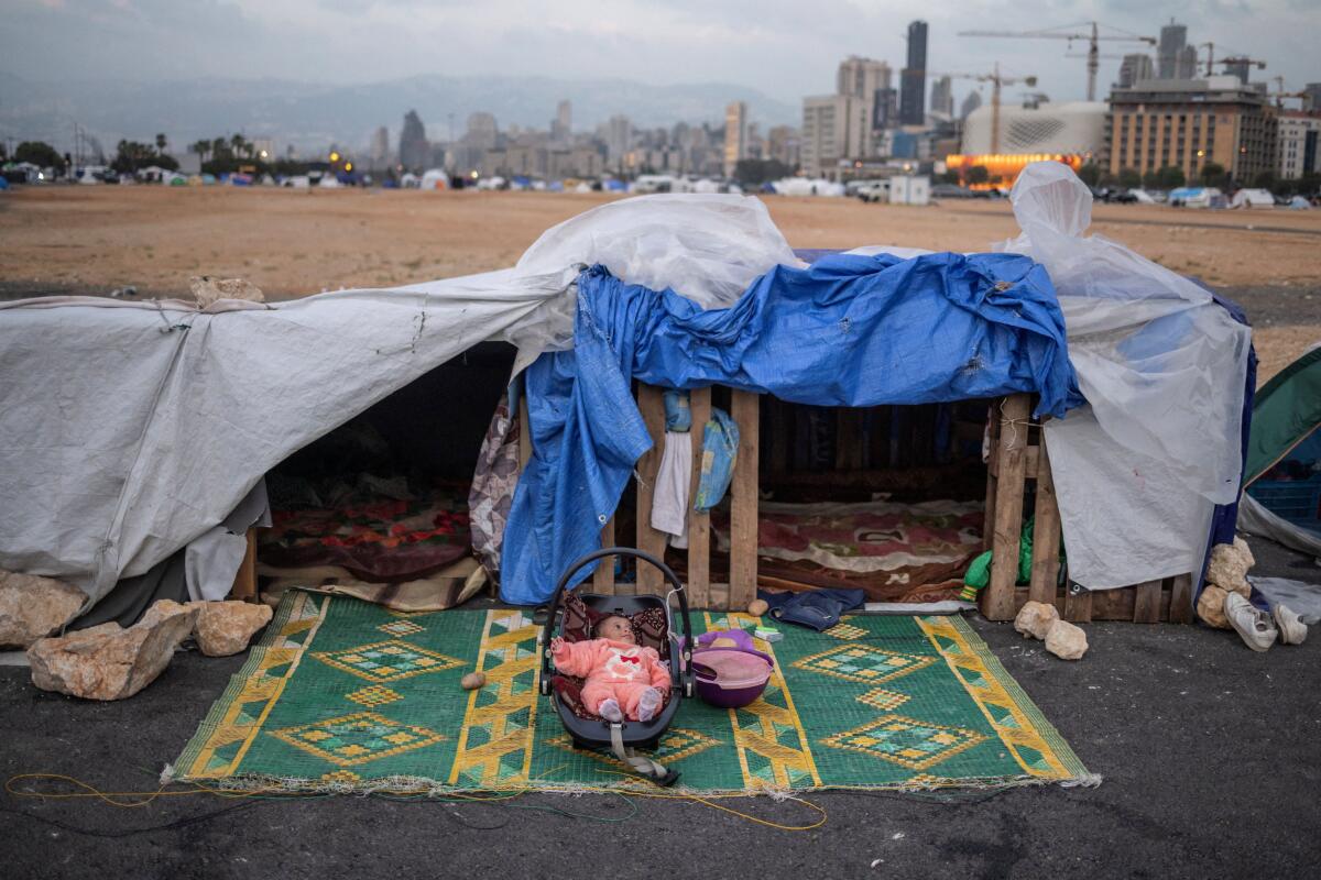 Alin, a two-months-old displaced baby girl, lies in her cradle at a makeshift encampment, after a 10-day ceasefire between Lebanon and Israel went into effect, in Beirut, Lebanon.