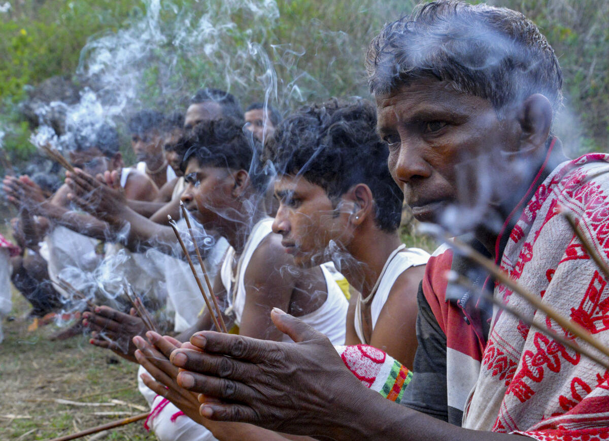 Tribal people perform rituals as part of the traditional Manda Puja at Bhoot village, a Maoist-affected area, in Khunti district of Jharkhand.