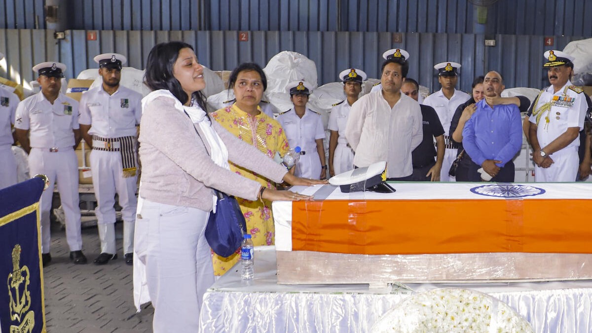 Indian Navy Lt. Vinay Narwal's wife breaks down while paying tribute to her husband after his mortal remains were brought at the cargo terminal of IGI Airport, in New Delhi, Wednesday, April 23, 2025.