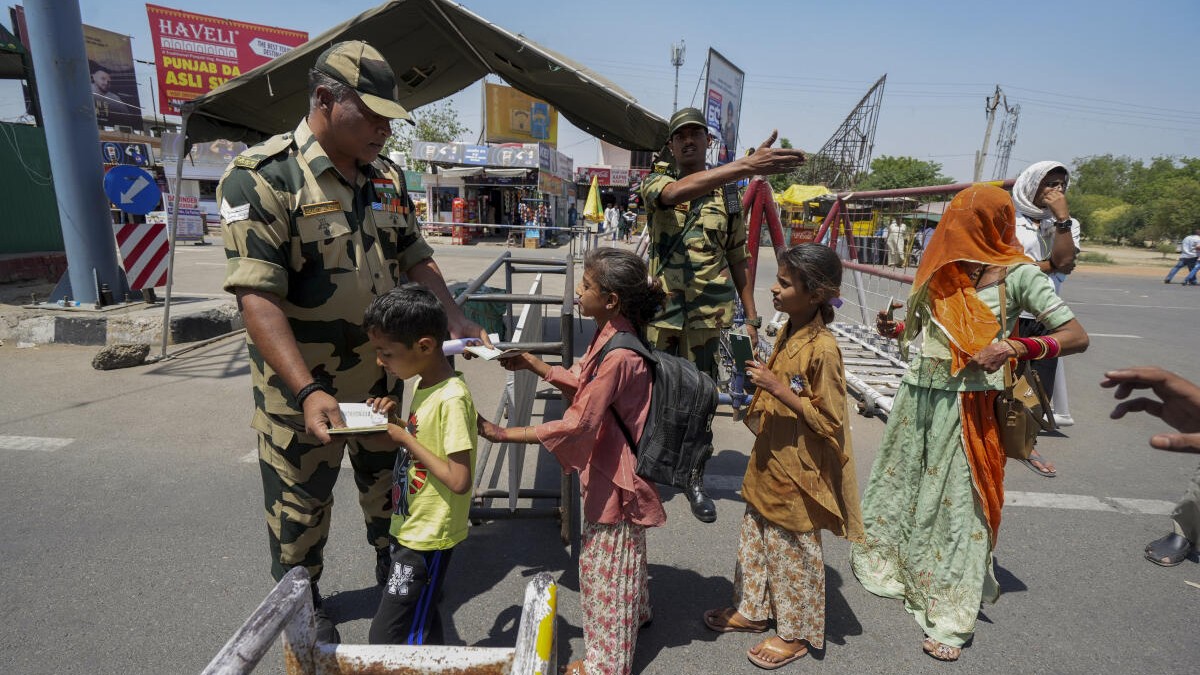 A BSF personnel checks documents of Pakistani nationals arriving to cross over to their country as the deadline to exit India nears its end, amid escalating tensions between the two countries over the Pahalgam terror attack, at the Attari-Wagah border point, near Amritsar, Sunday, April 27, 2025.