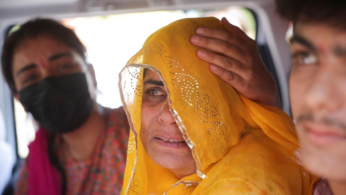Pakistani citizen Sarita Kanwer consoles her mother, Priya Kanwer, who is an Indian citizen and who couldn't accompany Sarita and her father, as they prepare to leave India after India revoked visas issued to Pakistani citizens, at the Attari-Wagah border crossing near Amritsar, India, April 27, 2025. India has suspended visa services to Pakistani nationals "with immediate effect" following an attack on tourists near Pahalgam in south Kashmir.