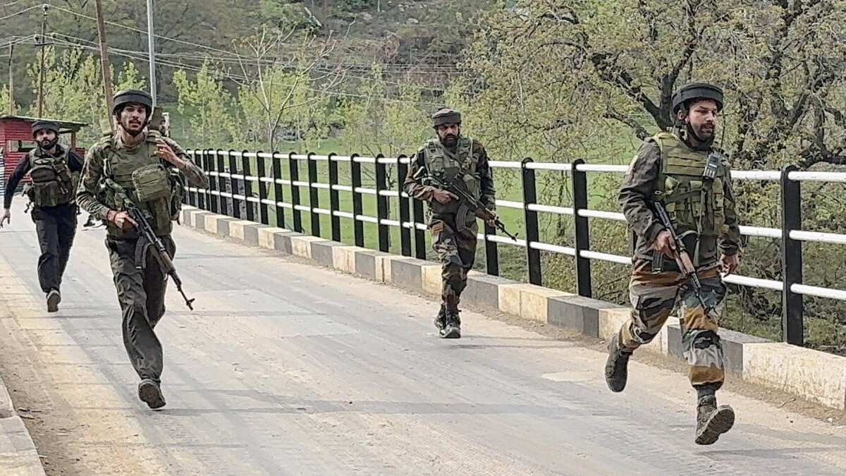 Security personnel rush to the spot after terrorists attacked a group of tourists at Pahalgam, in Anantnag district, Jammu &amp; Kashmir, Tuesday, April 22, 2025. At least 12 people suffered injuries in the attack, according to officials.