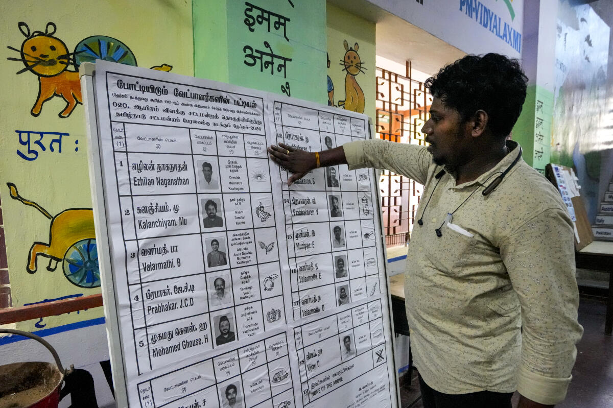 A poll official makes arrangements at a polling station on the eve of Tamil Nadu Assembly elections, in Chennai