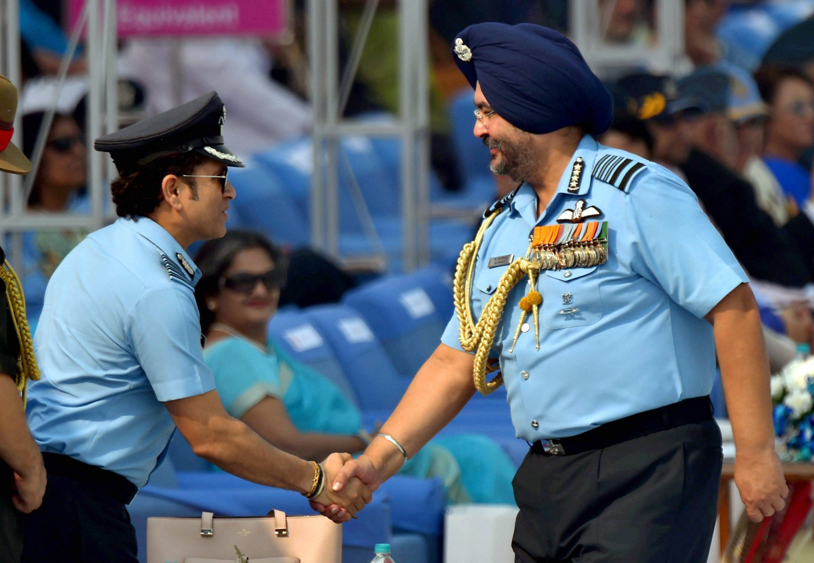 Captain of IAF, Sachin Tendulkar (L) being greeted by Air Chief Marshal BS Dhanoa during the 85th Air Force Day parade at Hindon Air Force base in Ghaziabad on Oct 8, 2017.
